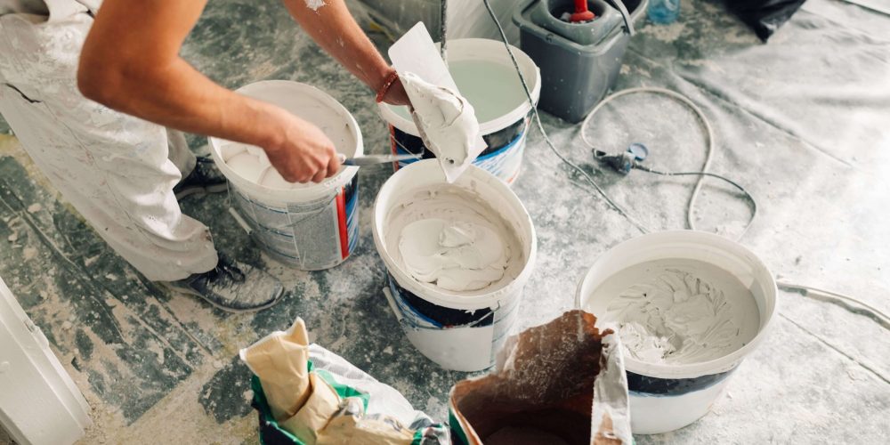 builder-s-hands-holding-trowel-and-spatula-a-work-2026-03-25-01-47-20-utc